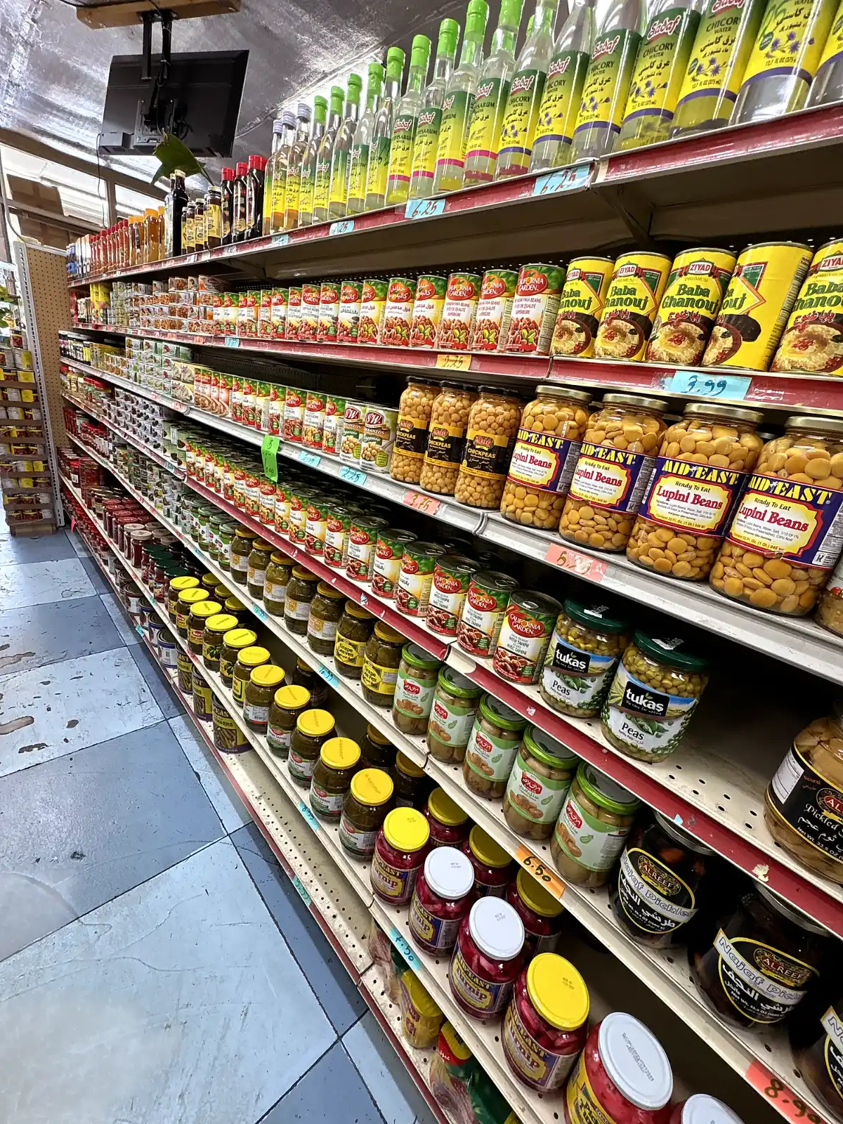 An aisle of packaged goods over the chequered floor