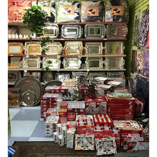 Stacked serving trays and boxed gift sets on the homeware wall