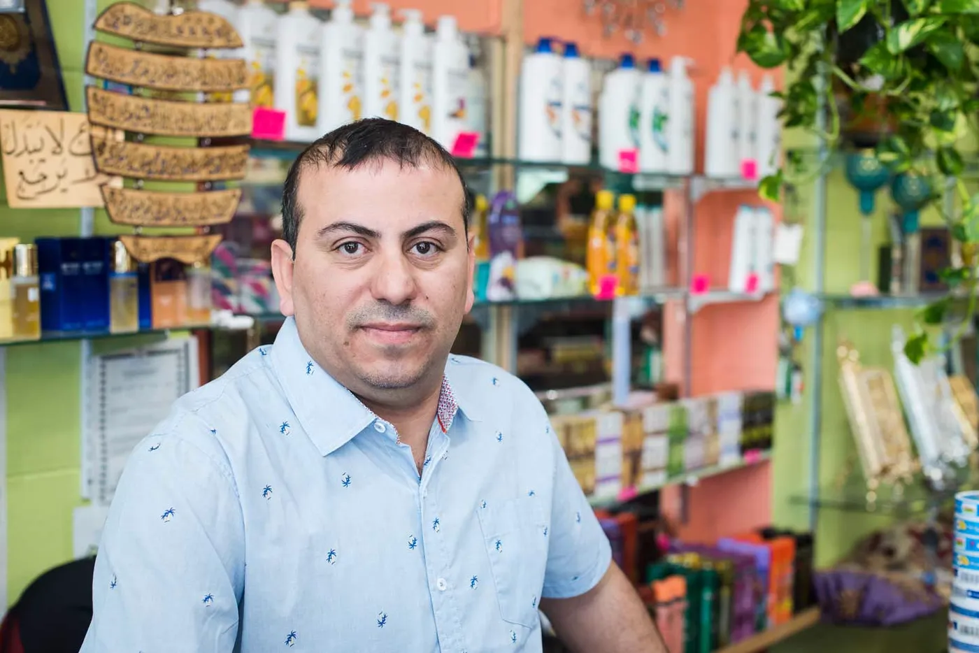 Jaafar, the owner, standing behind the counter of Alahmad Market