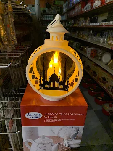 A lit lantern ornament on the shelf