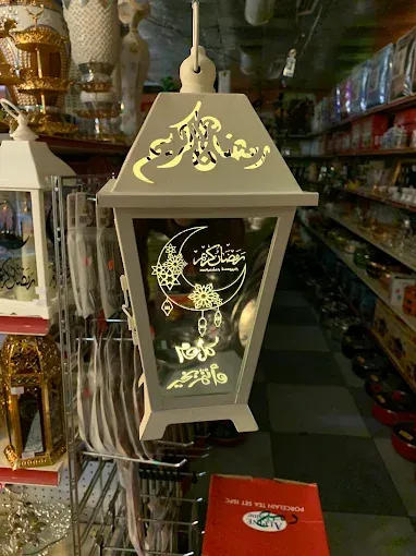 A white and gold Ramadan lantern on the shelf