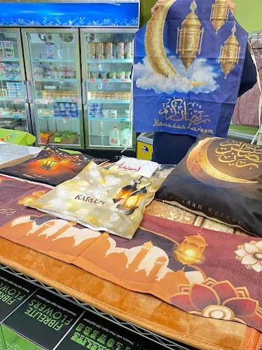 Prayer mats and Ramadan textiles laid out by the chillers