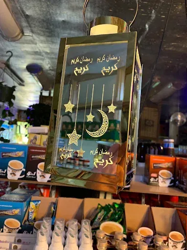 Ramadan lanterns and decorations displayed above the coffee cups