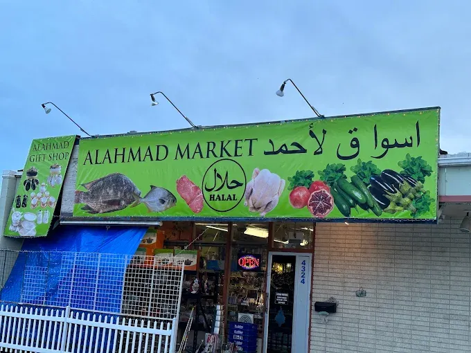 The green ALAHMAD MARKET awning over the shop front on Overland Road